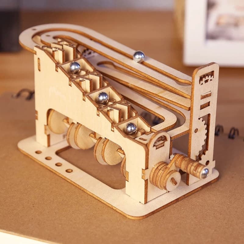 Assembled wooden Spiral marble run with metal marbles on its track