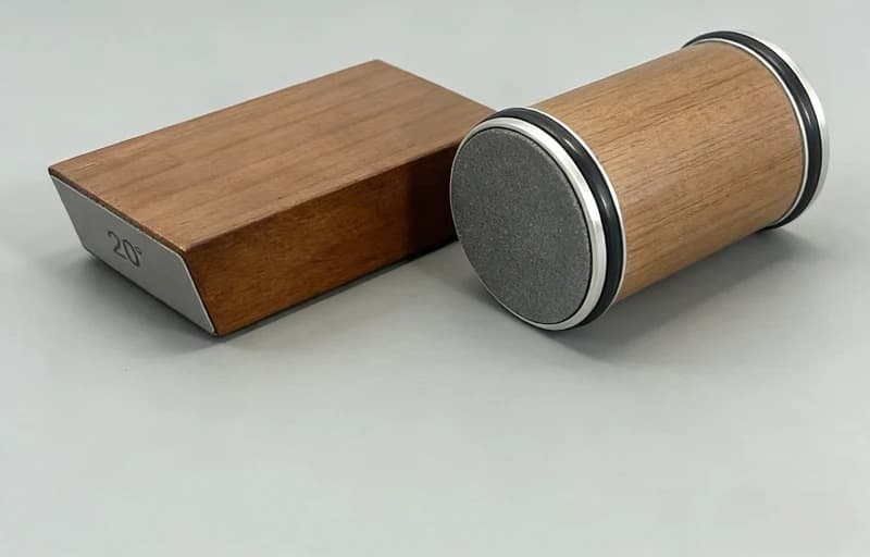 Rolling knife sharpener cylinder and angle block on a worktop