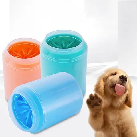 Person cleaning a dog's muddy paw with a silicone cup
